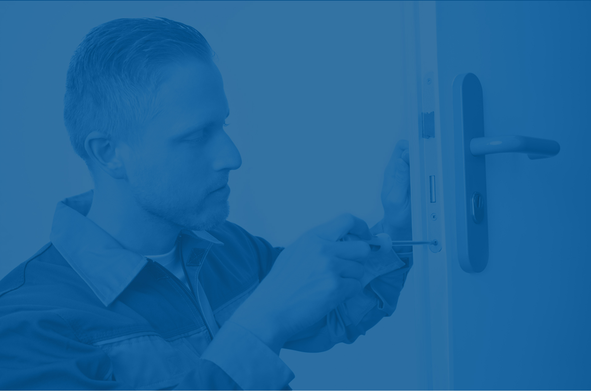 Man fitting a lever handle to a door, in blue tones