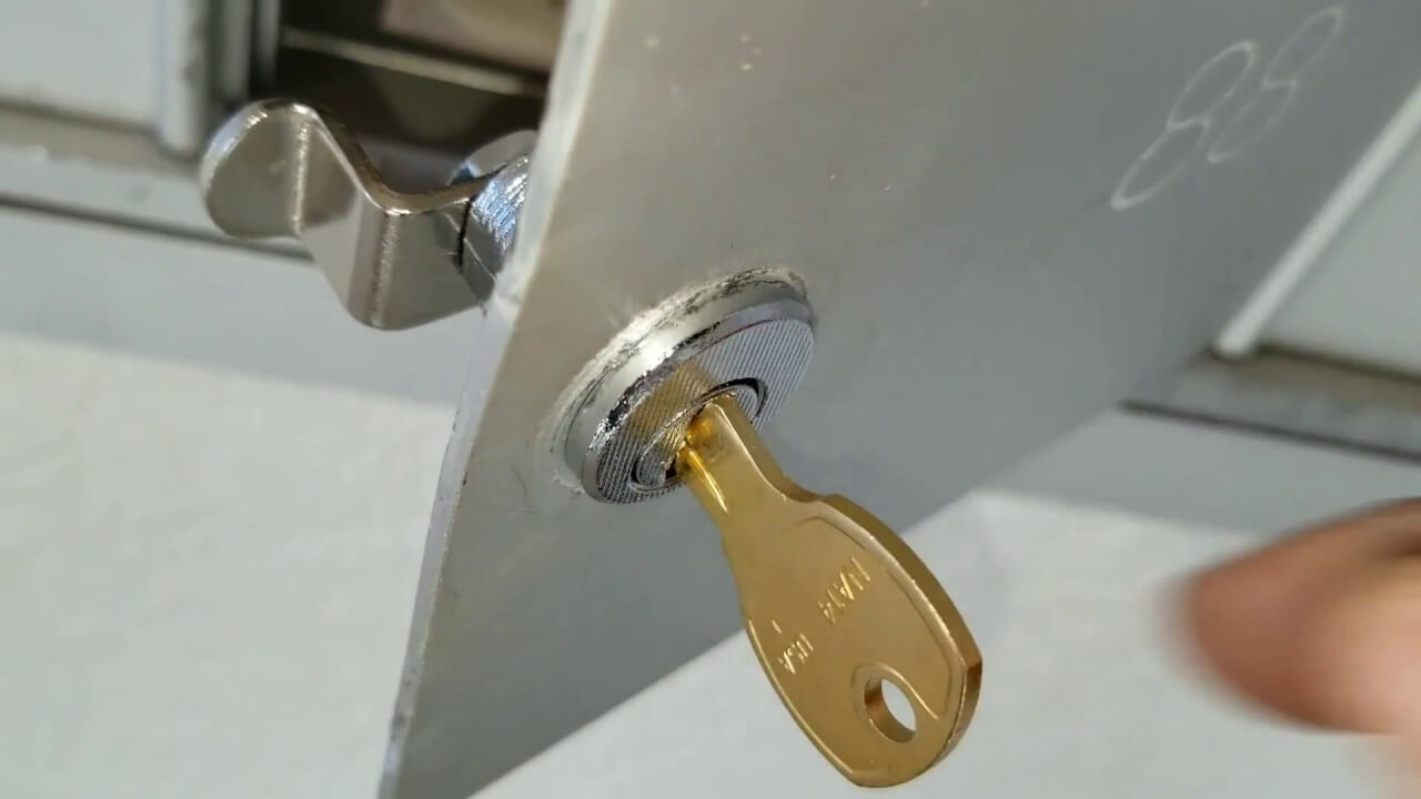 Mailbox door with its cam lock being replaced