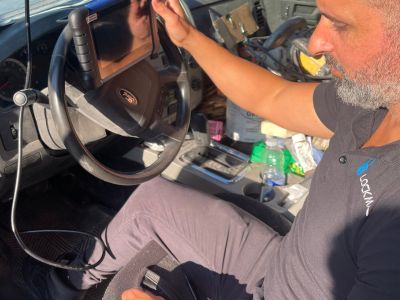 Automotive locksmith opening a car door professionally