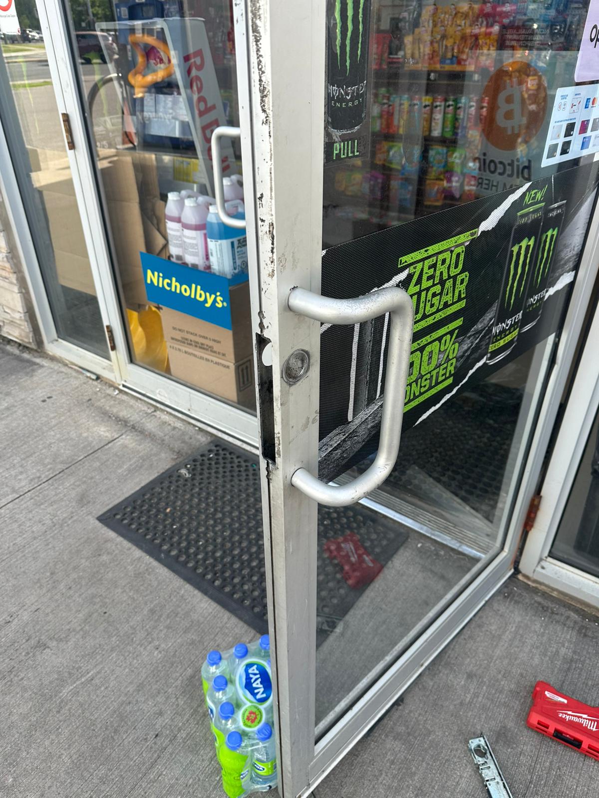Glass storefront entrance with a metal pull handle