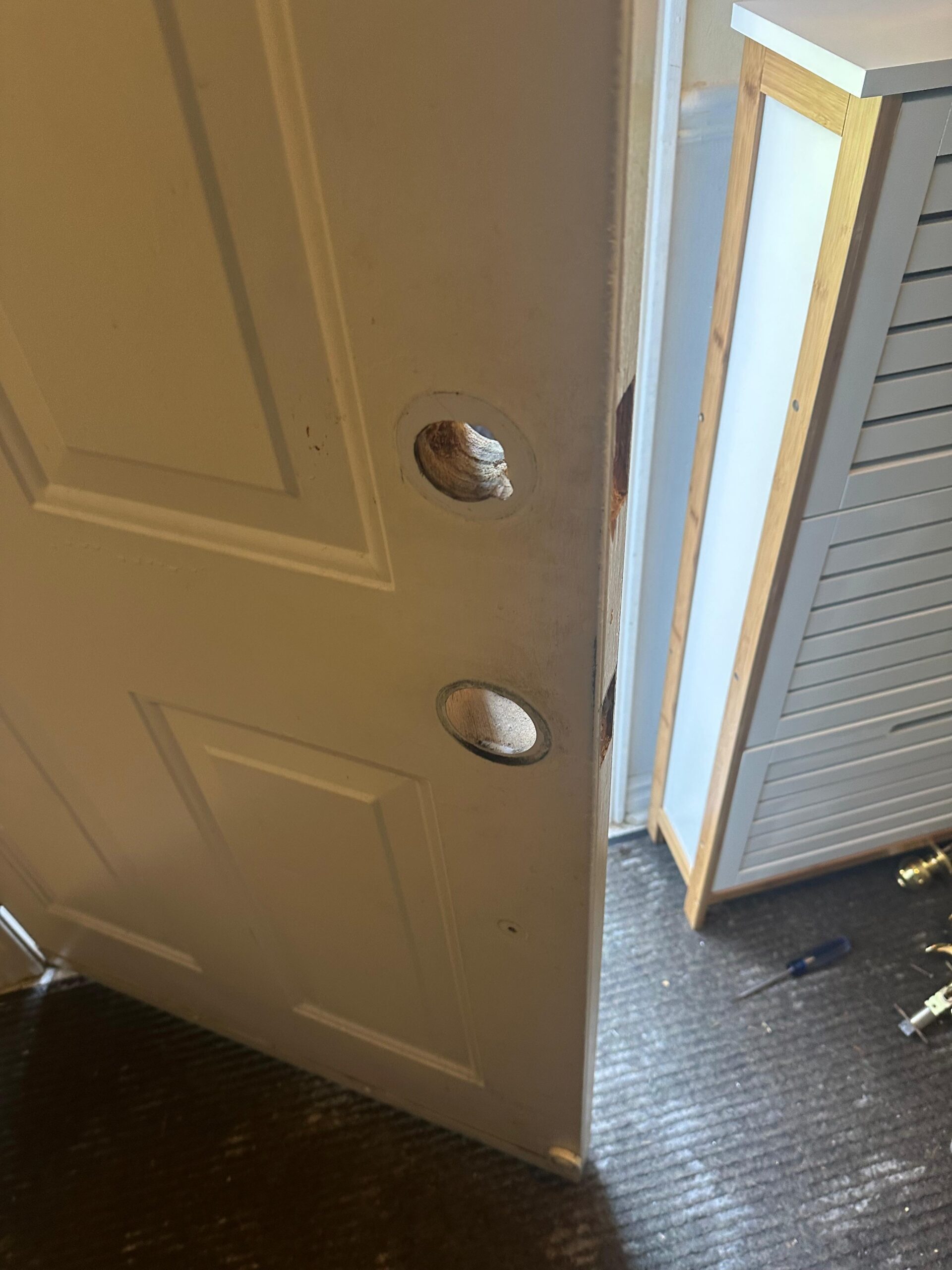 White panel door with openings prepared for replacement hardware