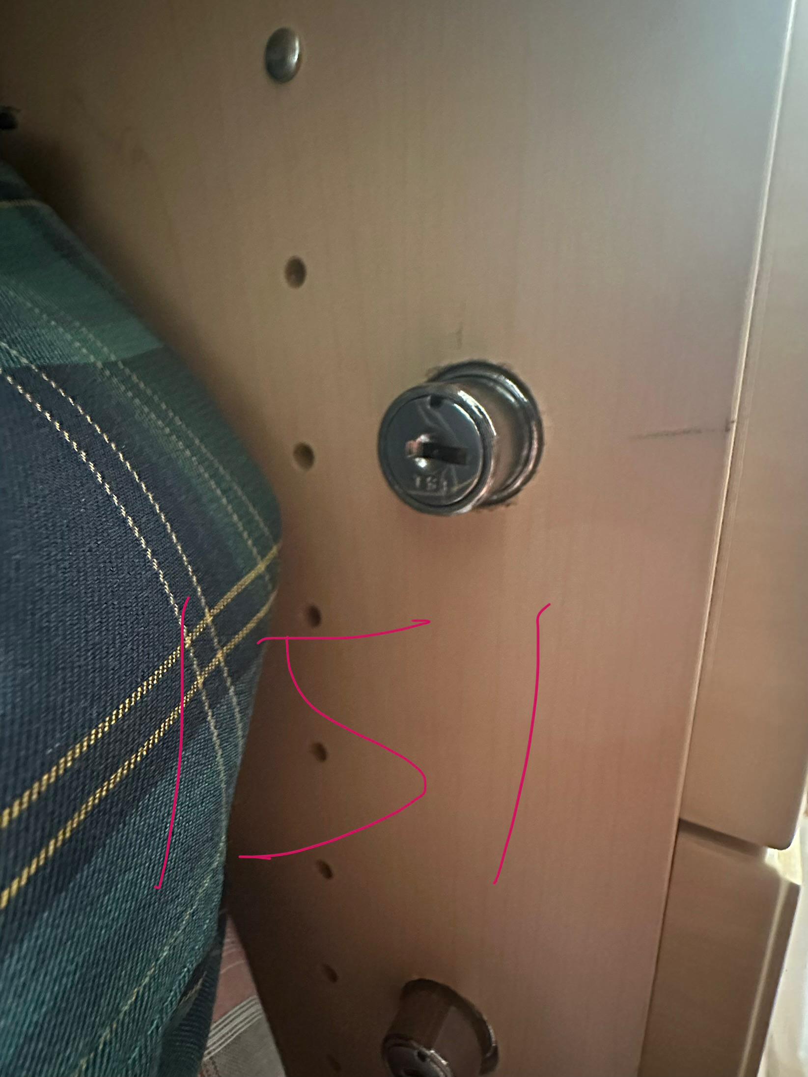 Two circular hardware openings on a residential door
