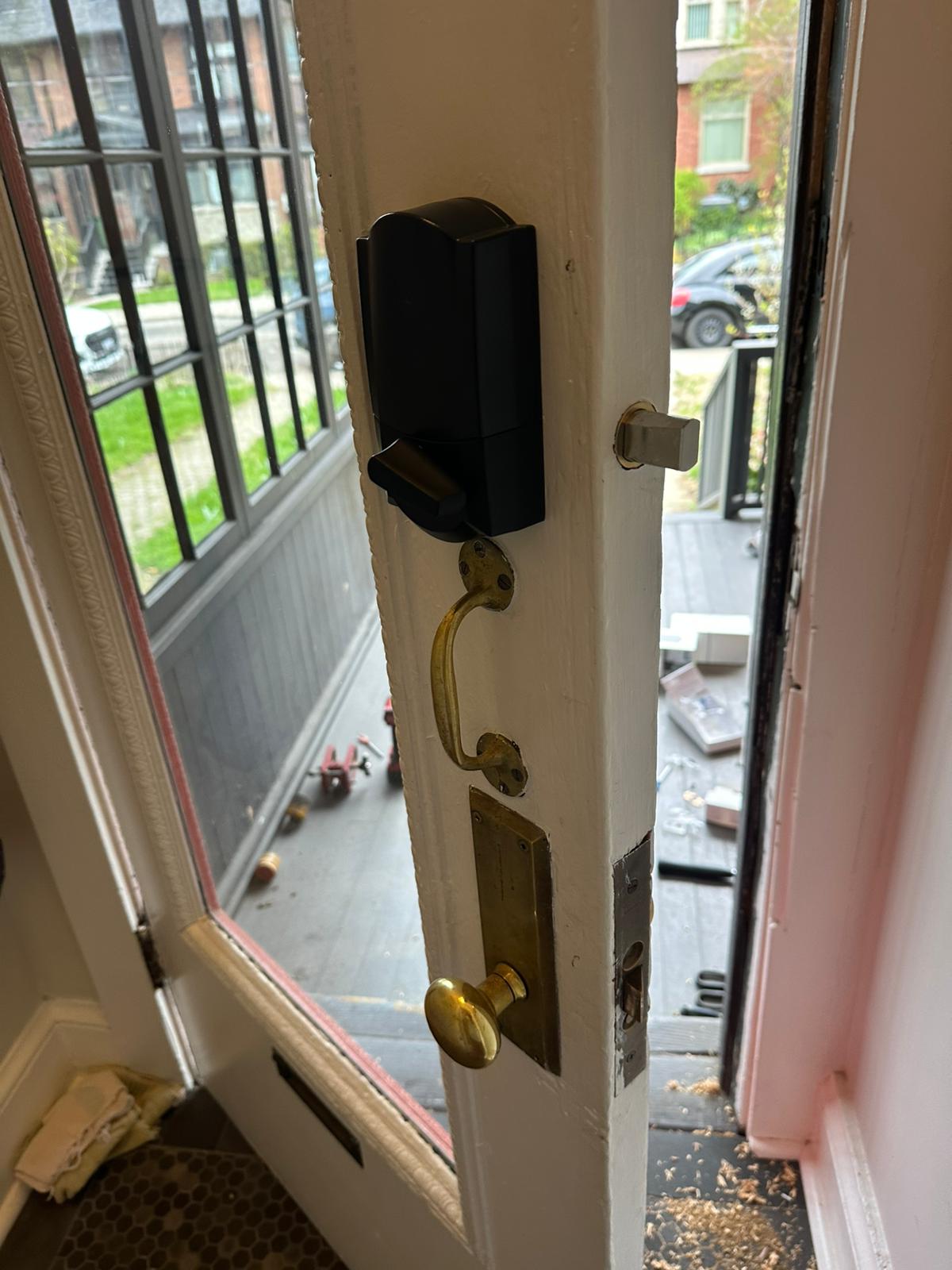Keypad deadbolt and handleset on a glazed entrance, seen from inside
