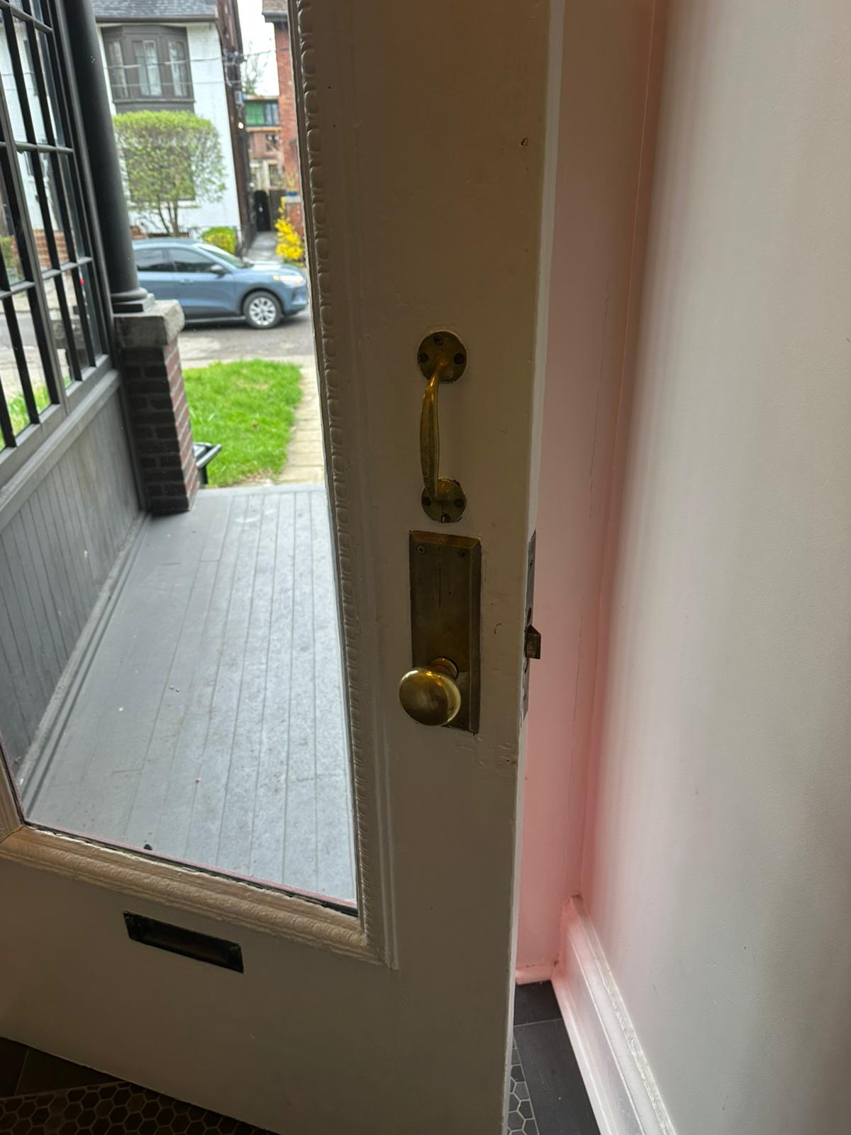 Inside face of a residential entrance with brass lock hardware