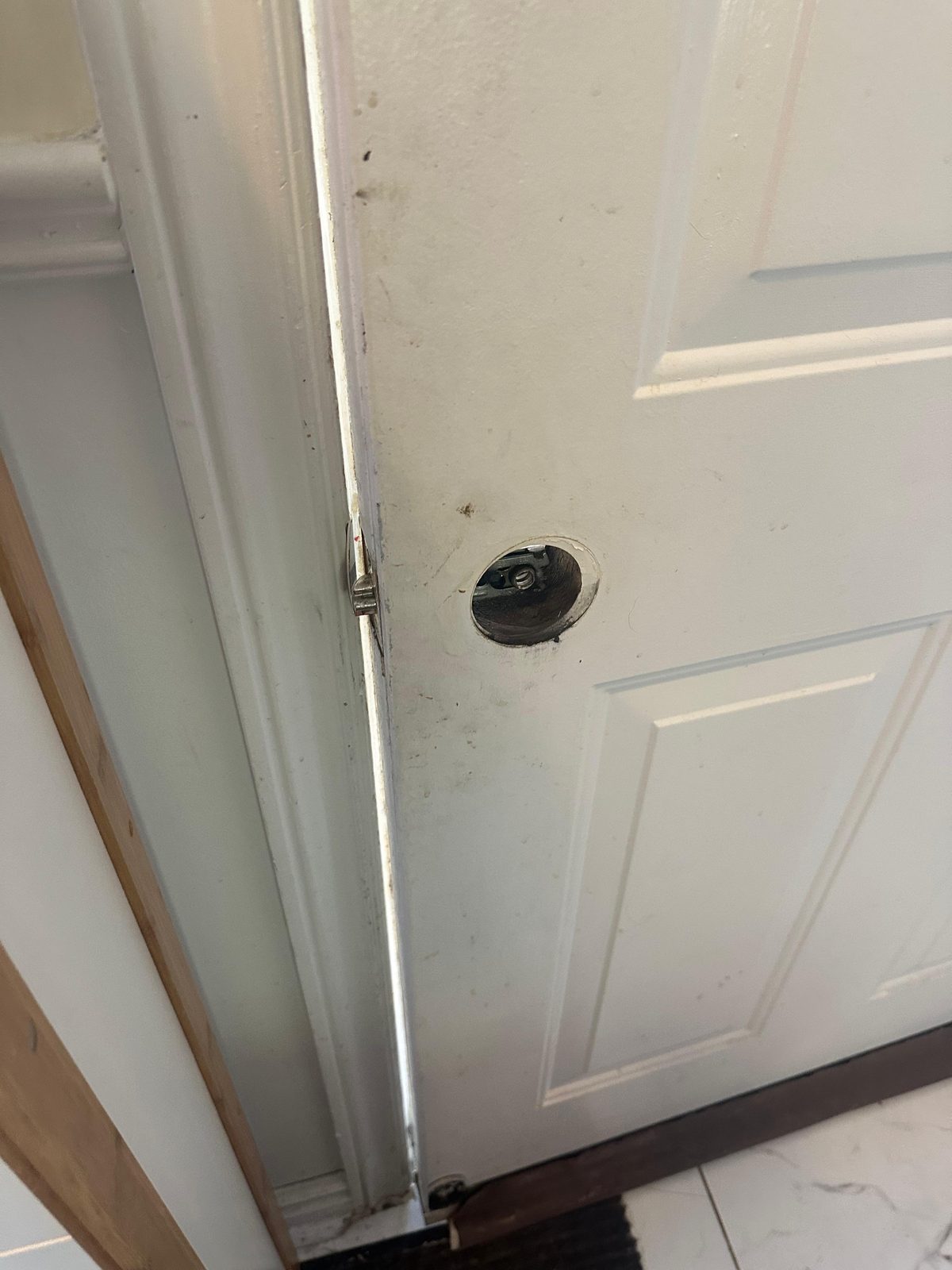 Single circular hardware opening prepared in a white door