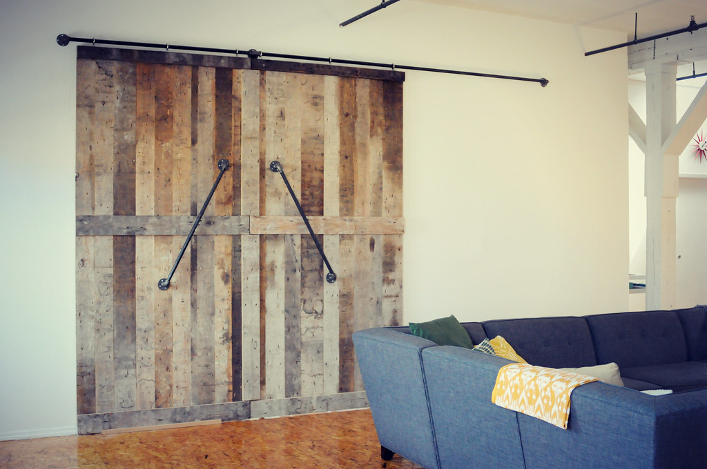 Sliding barn door on a rail in a living room