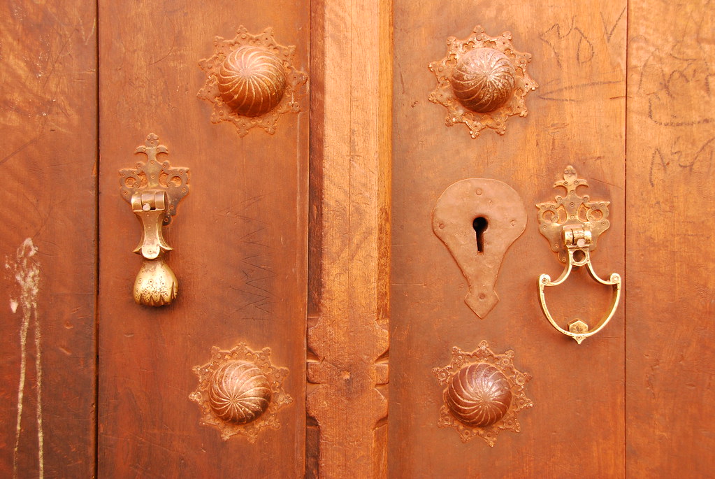 Solid wooden door with brass keyhole escutcheons