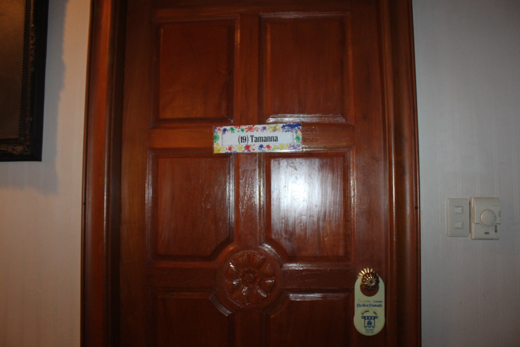 Wooden room door with a lever handle and a door hanger
